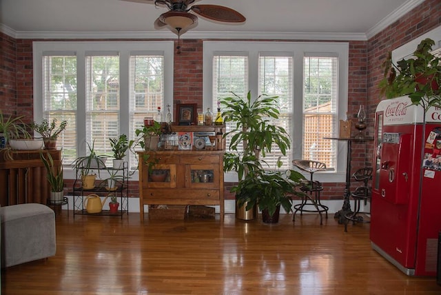 2122 S Hayden St, Amarillo, TX 79109 - living area featuring brick wall, ceiling fan, wood finished floors, and ornamental molding