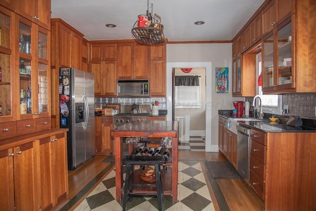 2122 S Hayden St, Amarillo, TX 79109 - kitchen featuring appliances with stainless steel finishes, decorative backsplash, dark countertops, brown cabinetry, and recessed lighting