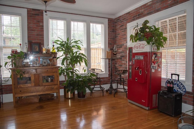 2122 S Hayden St, Amarillo, TX 79109 - sitting room with crown molding, plenty of natural light, wood finished floors, brick wall, and a ceiling fan