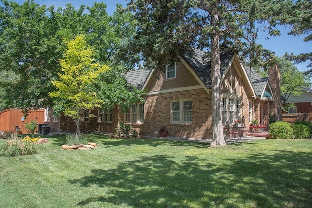 2122 S Hayden St, Amarillo, TX 79109 - back of house with a yard and brick siding