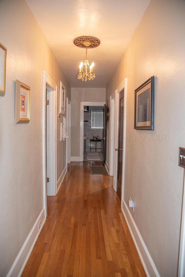 2122 S Hayden St, Amarillo, TX 79109 - hallway with a chandelier and wood-type flooring
