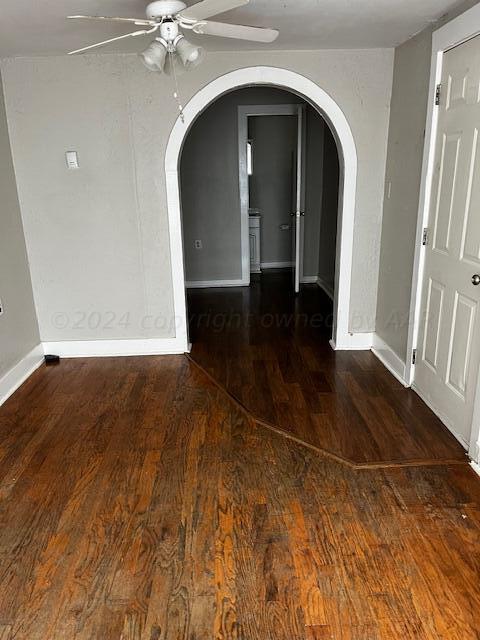 2122 S Hayden St, Amarillo, TX 79109 - spare room featuring ceiling fan, arched walkways, and wood finished floors