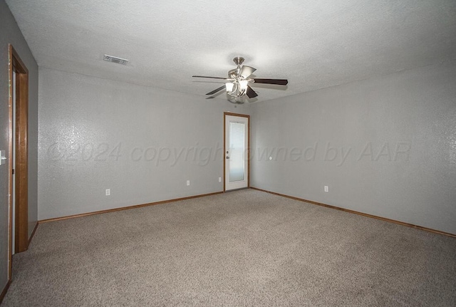 unfurnished room with ceiling fan, carpet, and a textured ceiling