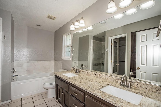 full bathroom featuring toilet, a textured ceiling, independent shower and bath, tile patterned floors, and vanity