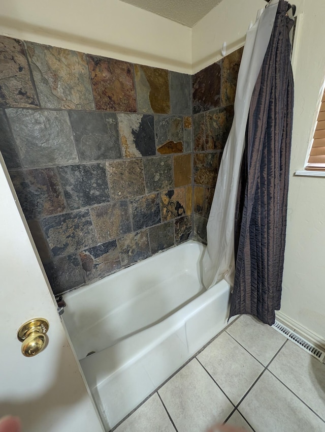 bathroom with shower / bath combination with curtain and tile patterned floors