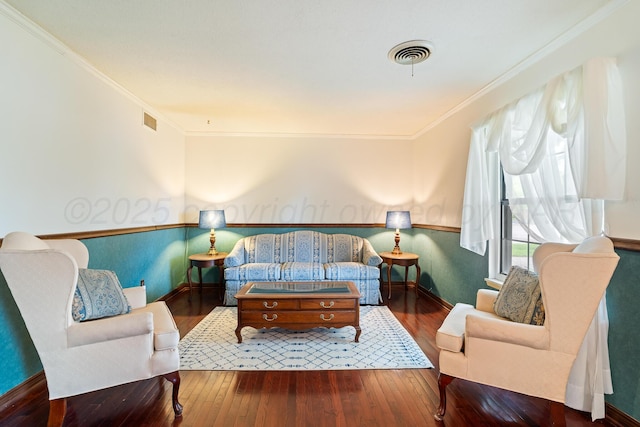 living area with hardwood / wood-style floors, crown molding, and baseboards