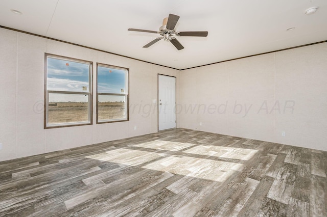 spare room with wood-type flooring and ceiling fan