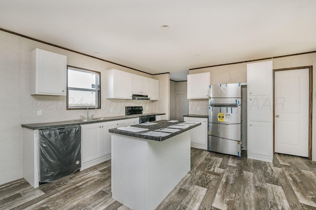 kitchen with black appliances, a center island, white cabinets, and sink