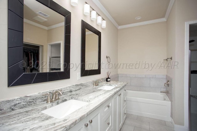 bathroom featuring a washtub, tile patterned flooring, crown molding, and vanity