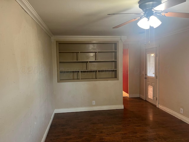 unfurnished room featuring built in shelves, crown molding, ceiling fan, and dark wood-type flooring