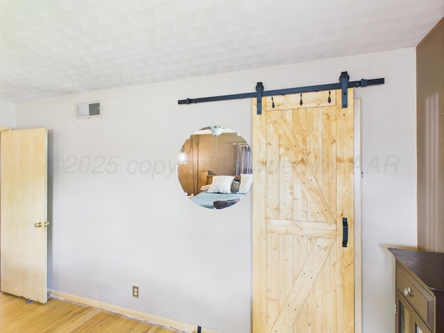 317 Morton Ave, Dumas, TX 79029 - interior space featuring a barn door and wood finished floors