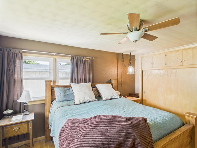 317 Morton Ave, Dumas, TX 79029 - bedroom featuring a closet, a ceiling fan, and wood finished floors