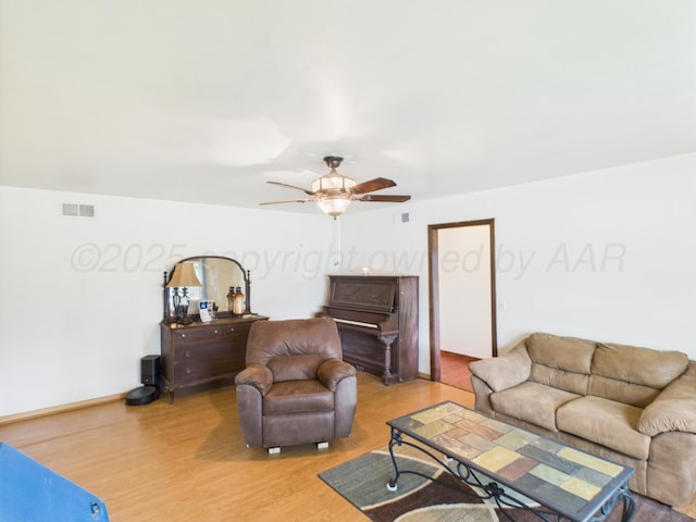 317 Morton Ave, Dumas, TX 79029 - living area with light wood-style floors and ceiling fan