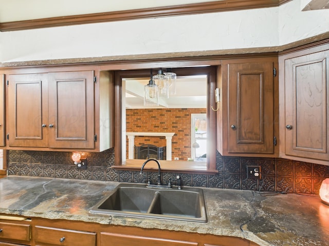 317 Morton Ave, Dumas, TX 79029 - kitchen with tasteful backsplash, brown cabinets, and crown molding
