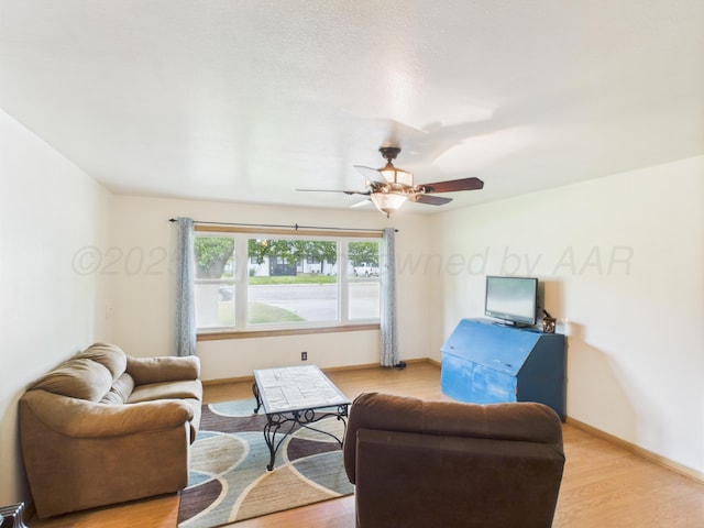 317 Morton Ave, Dumas, TX 79029 - living room featuring light wood-type flooring and ceiling fan
