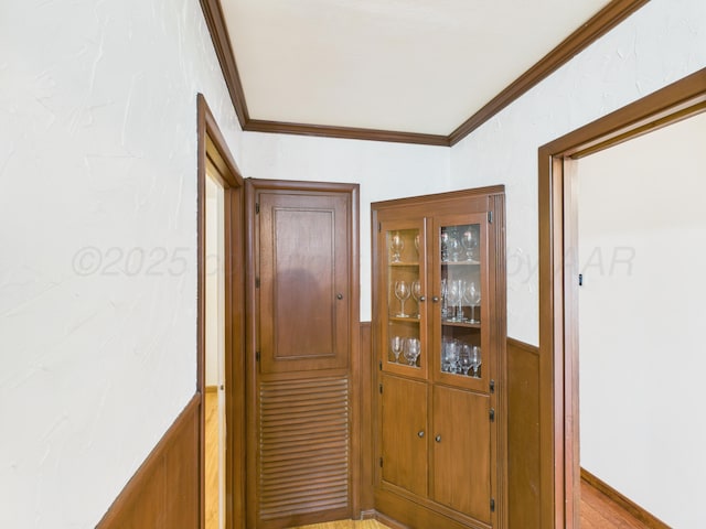 317 Morton Ave, Dumas, TX 79029 - hall with crown molding, wainscoting, and wood finished floors