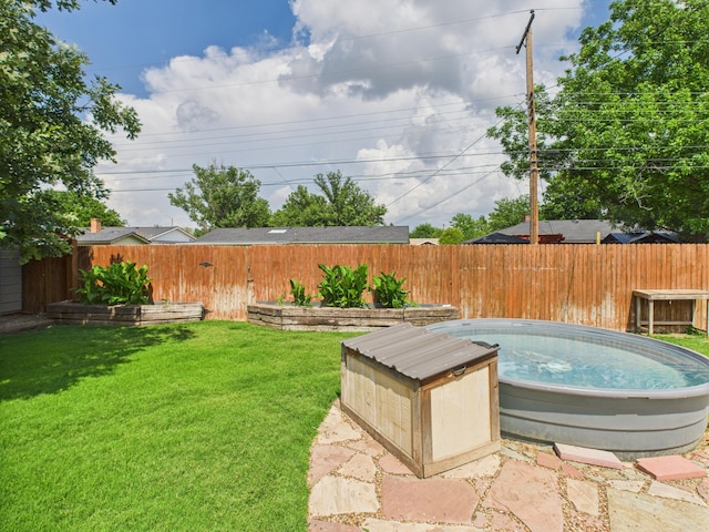 317 Morton Ave, Dumas, TX 79029 - fenced backyard with a jacuzzi