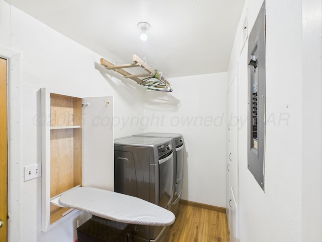 317 Morton Ave, Dumas, TX 79029 - laundry room featuring washer and dryer and wood finished floors