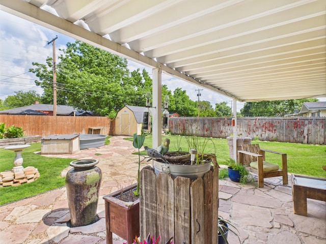 317 Morton Ave, Dumas, TX 79029 - fenced backyard with a patio area and a storage shed