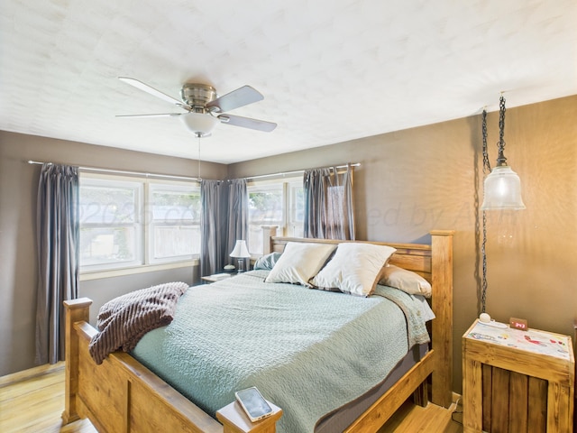317 Morton Ave, Dumas, TX 79029 - bedroom with light wood-style flooring and a ceiling fan