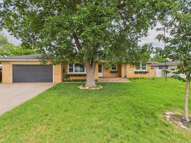 317 Morton Ave, Dumas, TX 79029 - view of front of home featuring an attached garage, concrete driveway, a front yard, and brick siding