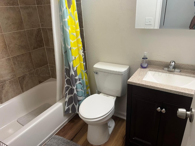 bathroom featuring vanity, toilet, shower / bath combo with shower curtain, and wood finished floors