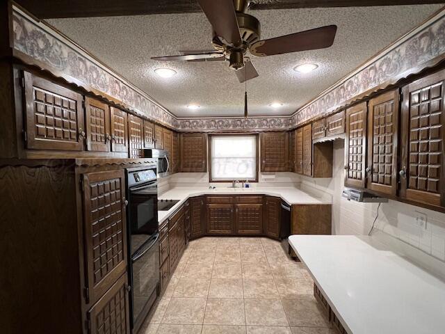 3102 S Main St, Perryton, TX 79070 - kitchen featuring a textured ceiling, a ceiling fan, light countertops, double wall oven, and ornamental molding