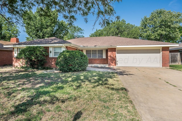 ranch-style house with a garage and a front yard