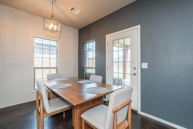 4607 Gloster St, Amarillo, TX 79118 - dining area with visible vents, baseboards, finished concrete floors, and an inviting chandelier