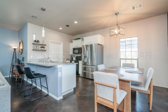 4607 Gloster St, Amarillo, TX 79118 - kitchen featuring a kitchen bar, black microwave, electric stove, stainless steel fridge, and white cabinetry