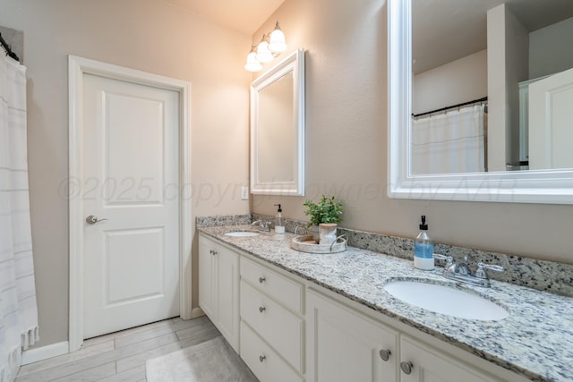 4607 Gloster St, Amarillo, TX 79118 - bathroom with double vanity, a sink, and wood finished floors