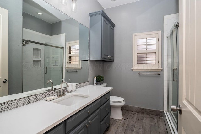 8121 Alexandria Ave, Amarillo, TX 79118 - full bath with vanity, wood finished floors, a shower stall, and toilet