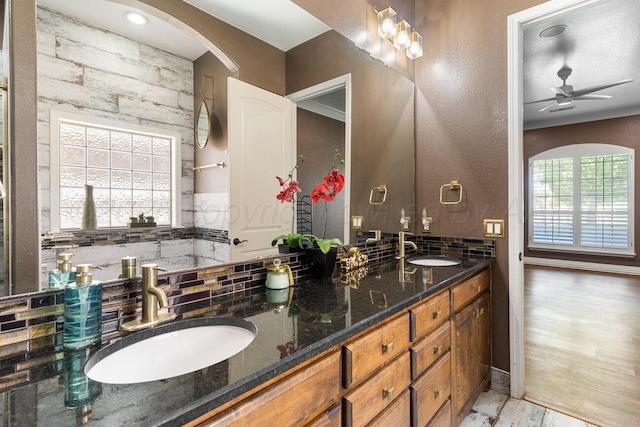 8121 Alexandria Ave, Amarillo, TX 79118 - bathroom with double vanity, tasteful backsplash, and ceiling fan