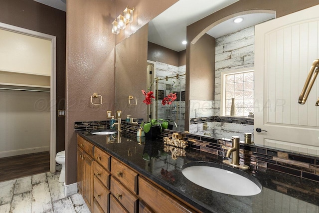 8121 Alexandria Ave, Amarillo, TX 79118 - bathroom featuring toilet, double vanity, and a shower stall