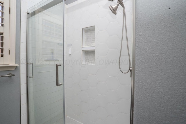 8121 Alexandria Ave, Amarillo, TX 79118 - full bath featuring a stall shower, a textured wall, and a towel warming rack