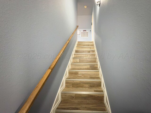 8121 Alexandria Ave, Amarillo, TX 79118 - stairs featuring wood finished floors and a textured wall