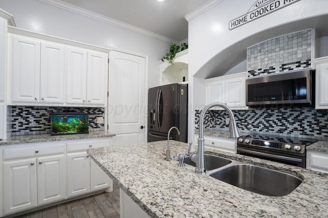8121 Alexandria Ave, Amarillo, TX 79118 - kitchen with stainless steel appliances, white cabinetry, decorative backsplash, and ornamental molding
