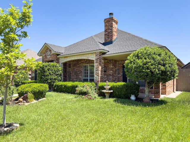 8121 Alexandria Ave, Amarillo, TX 79118 - view of home's exterior featuring brick siding, a yard, roof with shingles, and a chimney