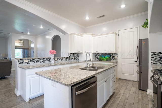 8121 Alexandria Ave, Amarillo, TX 79118 - kitchen with appliances with stainless steel finishes, a sink, light wood finished floors, white cabinetry, and ornamental molding