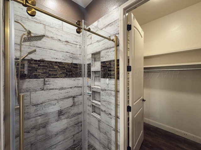 8121 Alexandria Ave, Amarillo, TX 79118 - bathroom with a shower stall, wood finished floors, a spacious closet, and baseboards