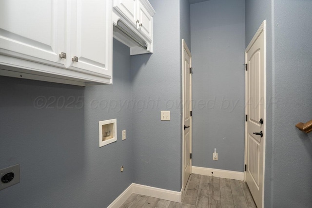 8121 Alexandria Ave, Amarillo, TX 79118 - laundry room with electric dryer hookup, cabinet space, light wood finished floors, washer hookup, and baseboards
