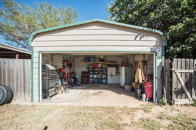 detached garage featuring fence