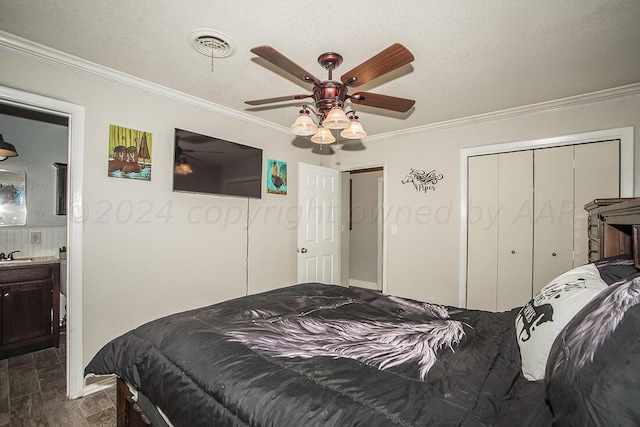 bedroom with dark wood-type flooring, a closet, a sink, and crown molding