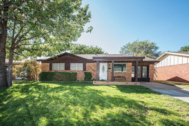 ranch-style home with a front lawn and brick siding