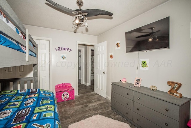 bedroom with dark wood-type flooring and a ceiling fan