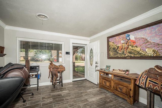 foyer featuring a textured ceiling, visible vents, baseboards, ornamental molding, and wood tiled floor