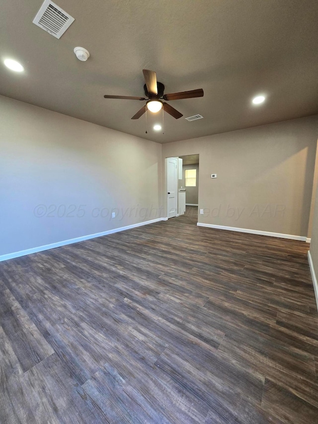 empty room featuring dark hardwood / wood-style floors and ceiling fan