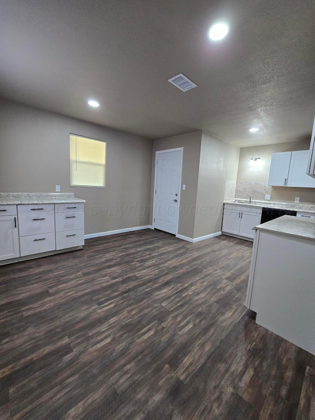 kitchen featuring white cabinetry, dark wood-type flooring, and a textured ceiling