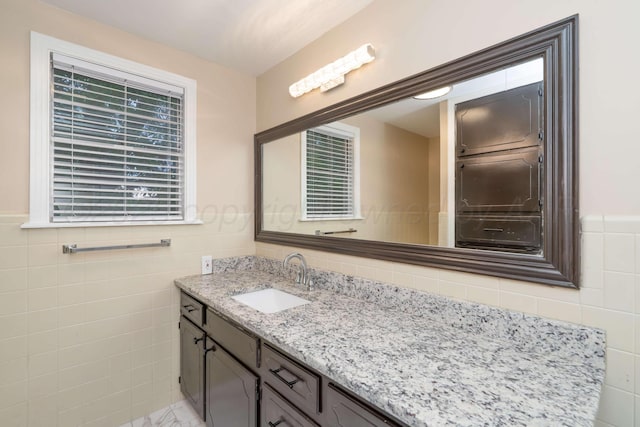 3408 Hawthorne Dr, Amarillo, TX 79109 - bathroom featuring tile walls, vanity, and a wainscoted wall