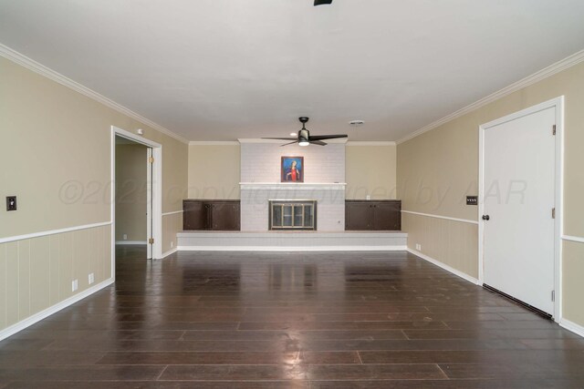 3408 Hawthorne Dr, Amarillo, TX 79109 - unfurnished living room with a ceiling fan, wood finished floors, a fireplace, crown molding, and wainscoting